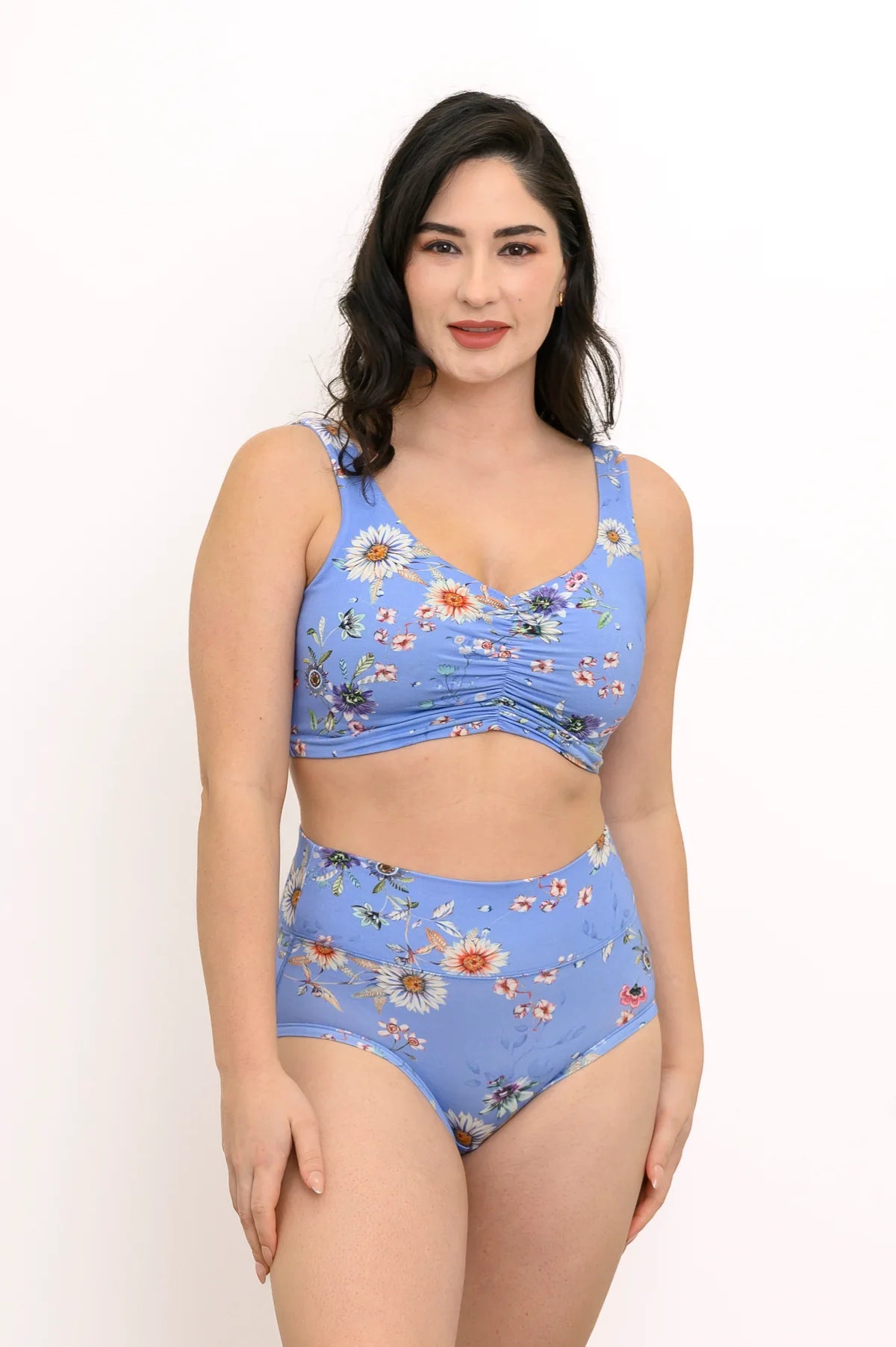 Woman wearing a blue floral bikini set on a white background