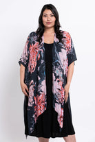 Woman wearing a floral kimono over a black dress on a white background