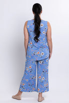 Woman wearing a blue floral outfit with a white background