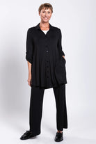Person wearing a black outfit on a white background