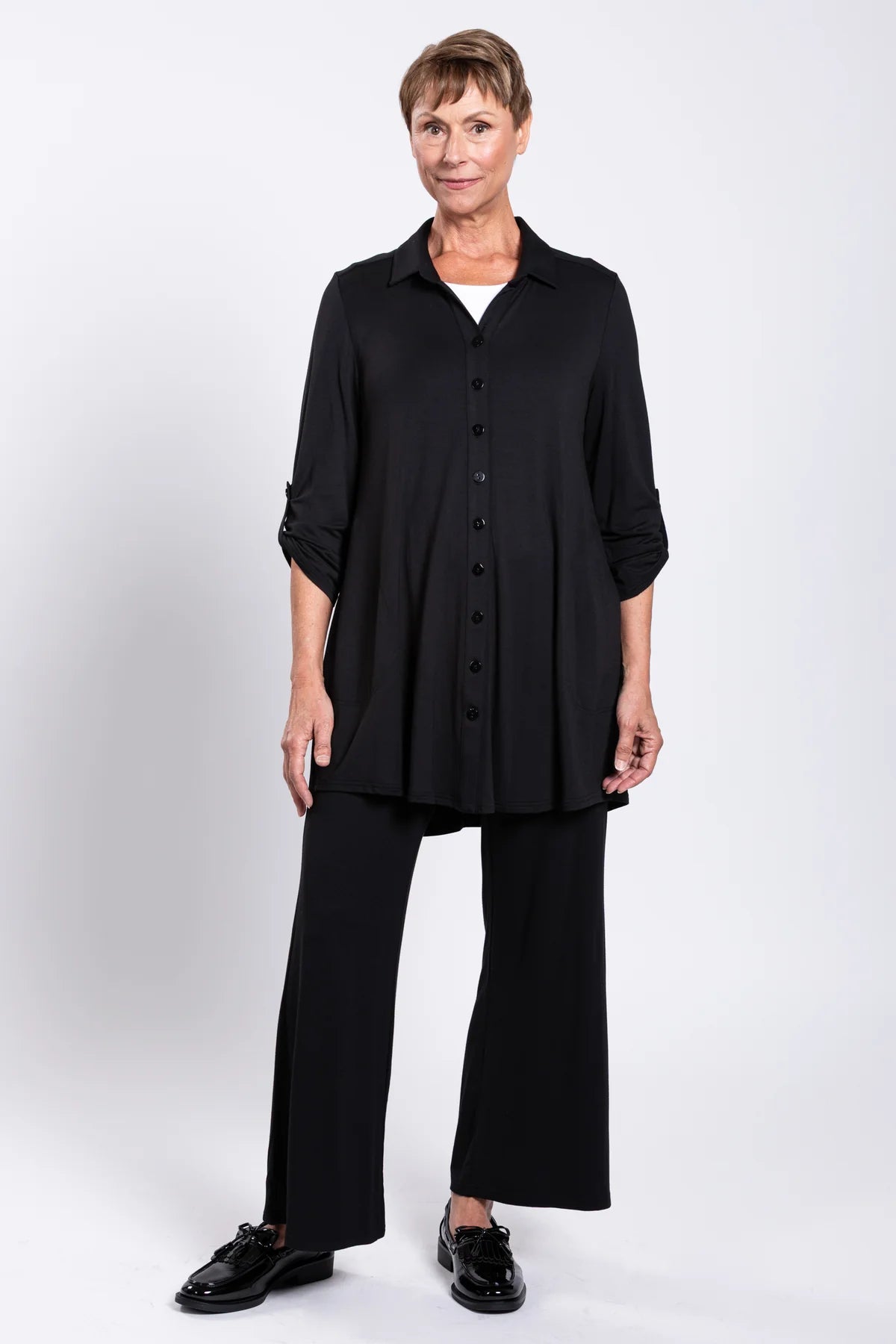 Person wearing a black outfit on a white background