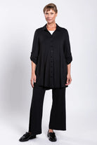 Person wearing a black outfit on a white background