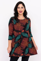 Woman wearing a patterned dress on a white background