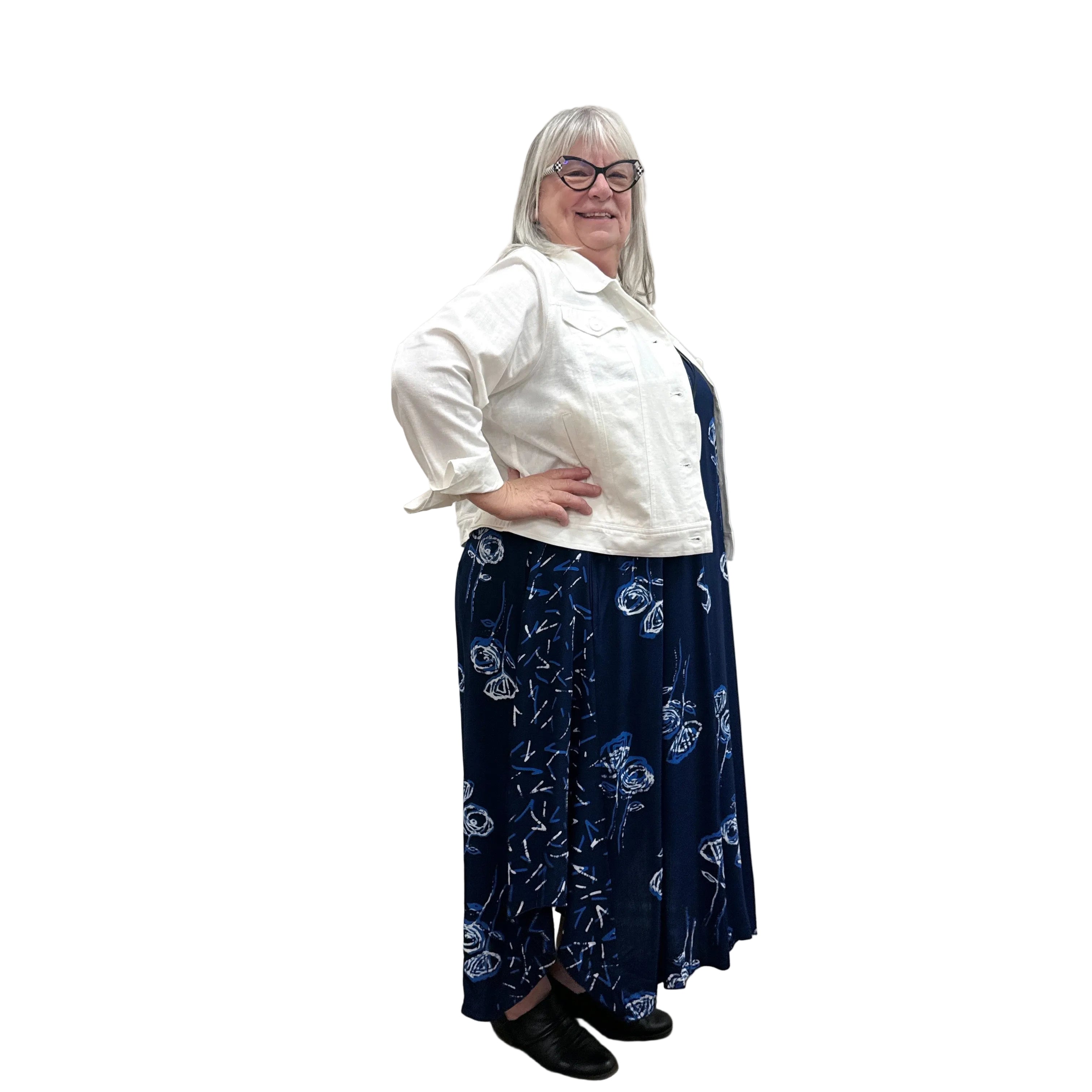 Woman wearing a white Blue Sky Colleen Jacket over a navy dress on white background. 