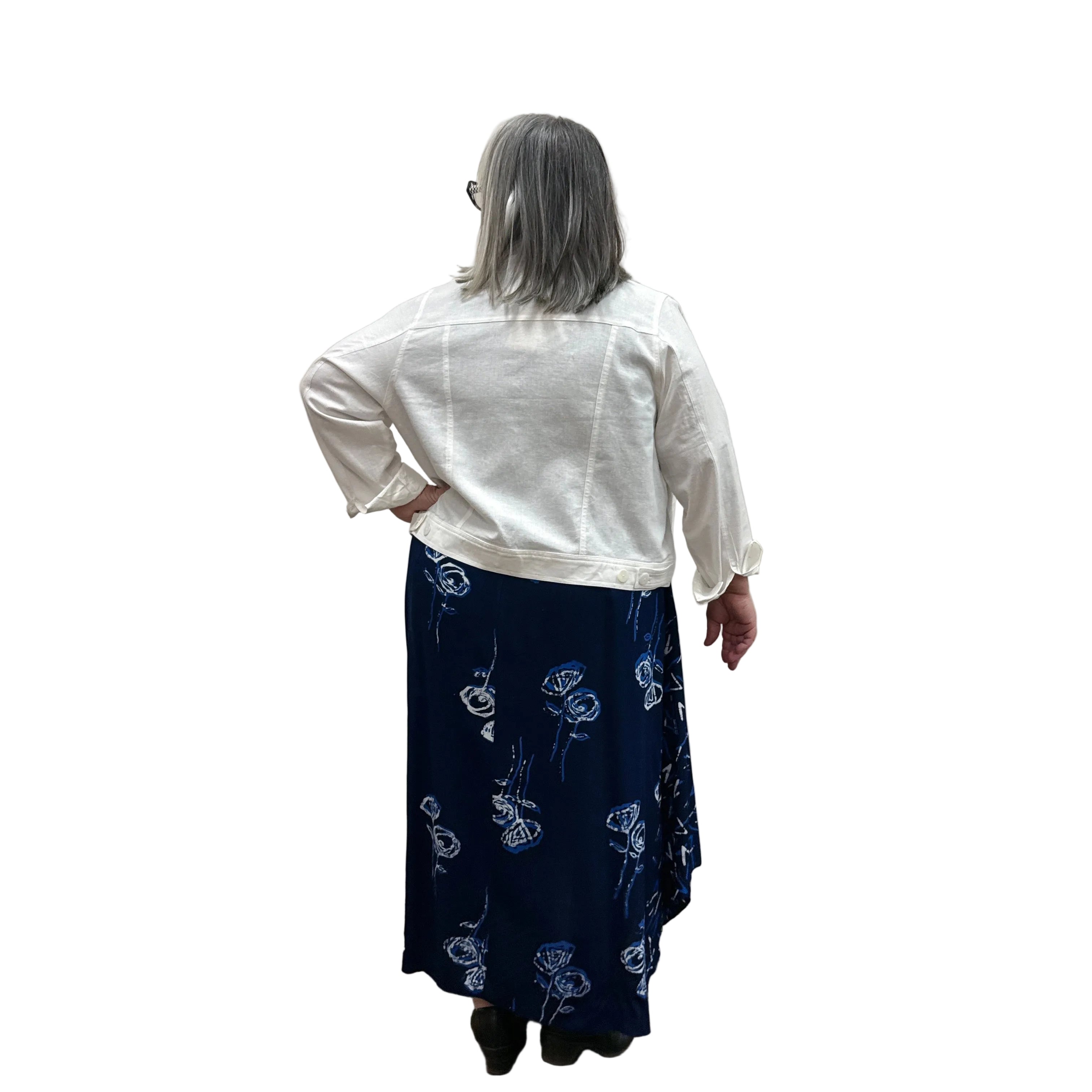 Woman wearing a white Blue Sky Colleen Jacket over a navy dress on white background. 