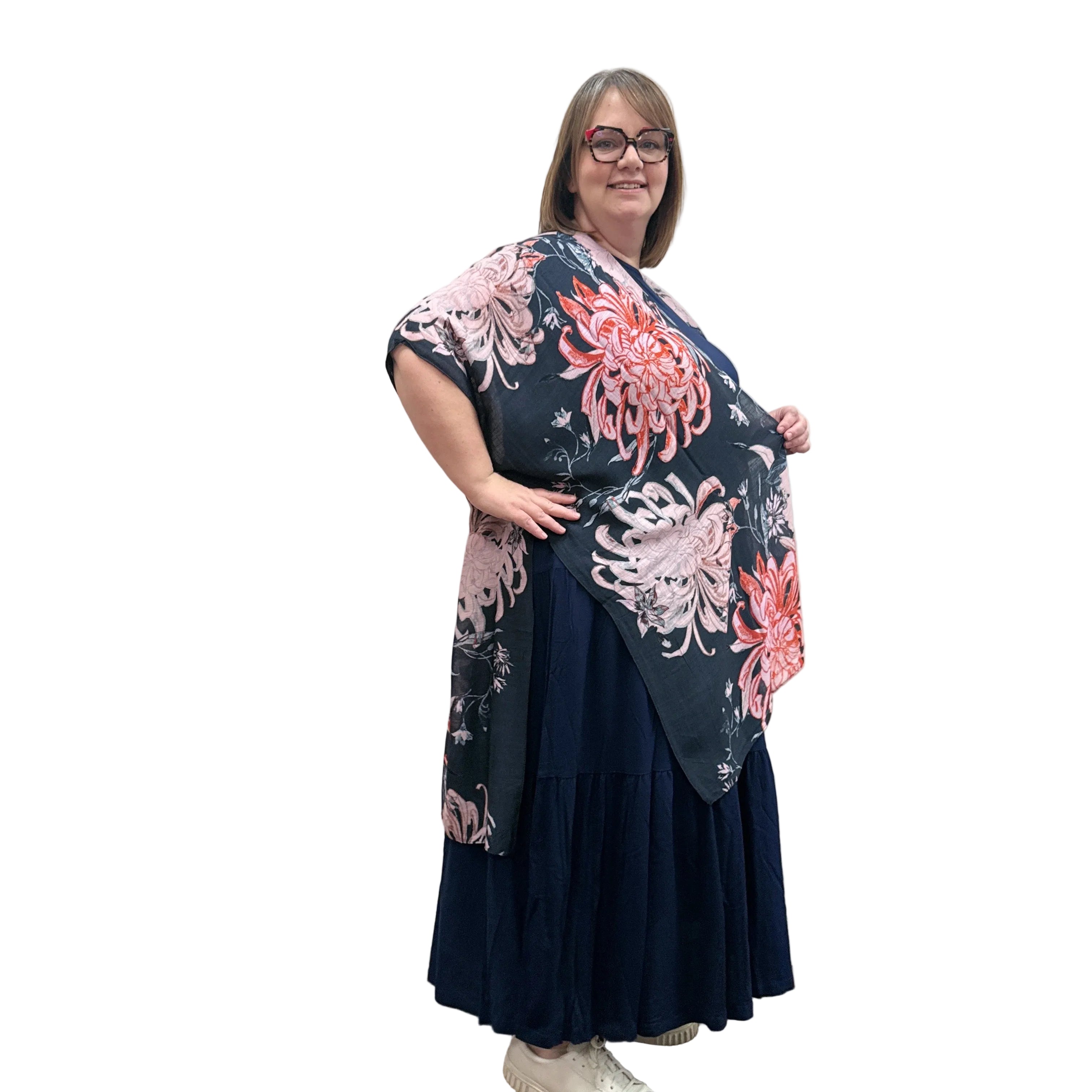 Woman wearing a floral Blue Sky Darcy kimono on a white background. 