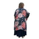 Woman wearing a floral Blue Sky Darcy kimono on a white background. 