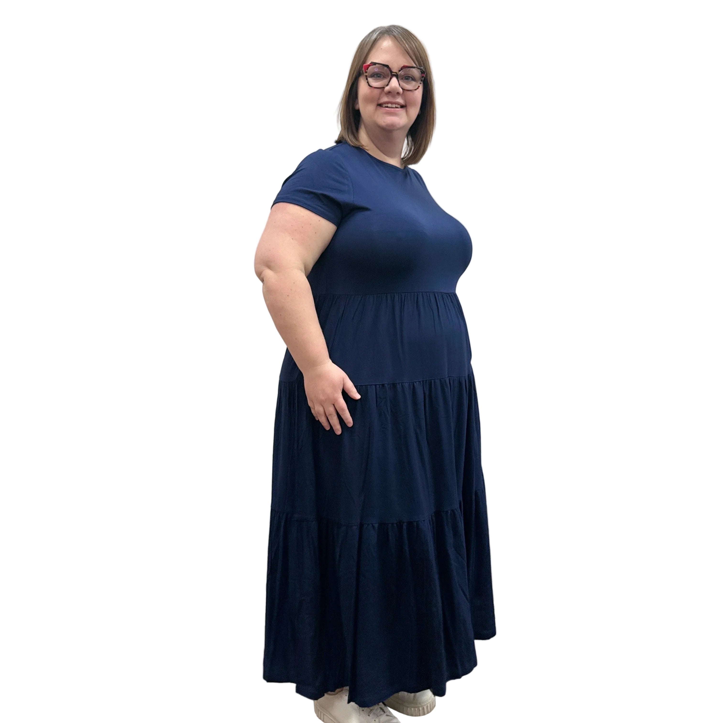 Woman wearing a dark blue Blue Sky Erin dress against a white background