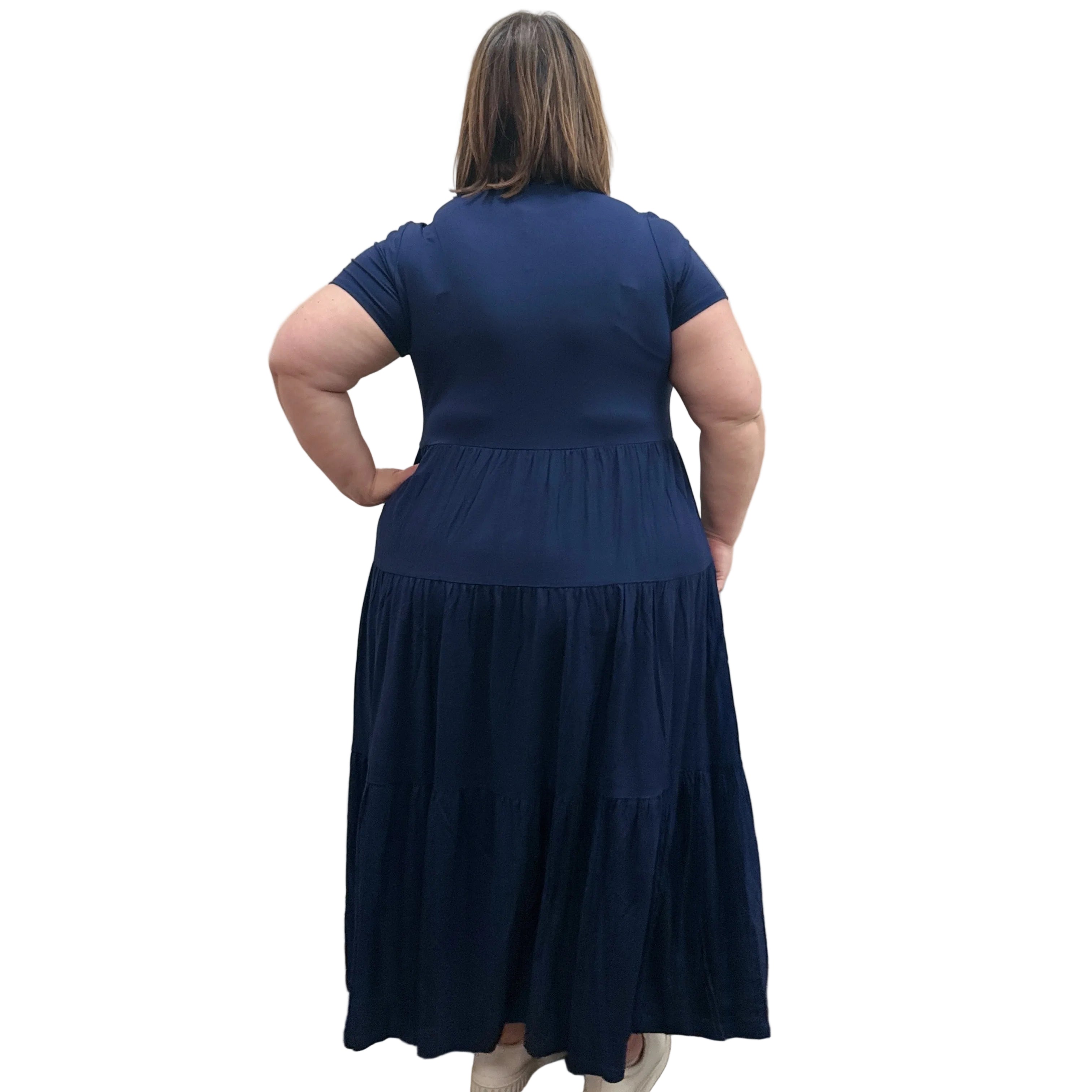 Woman wearing a dark blue Blue Sky Erin dress against a white background