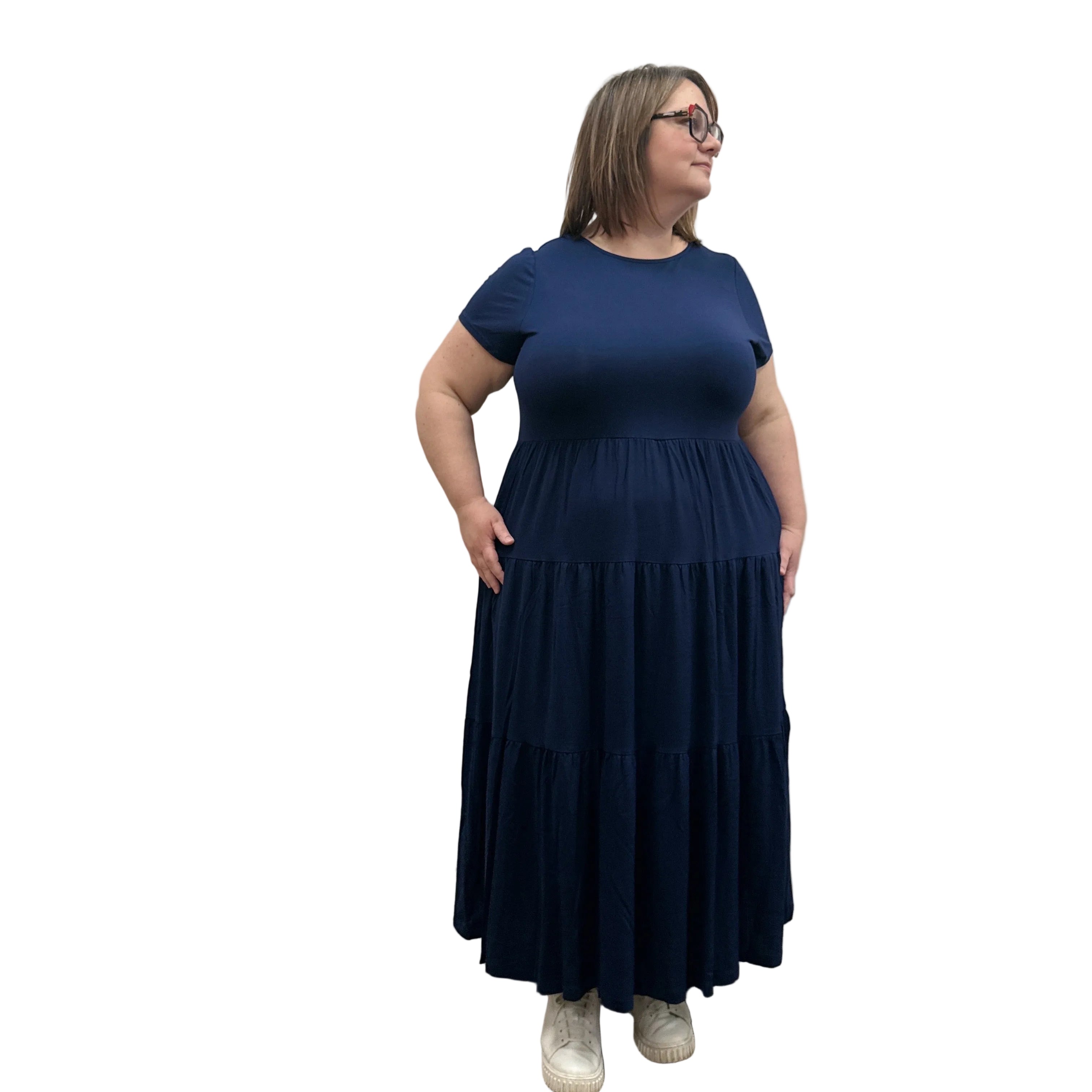 Woman wearing a dark blue Blue Sky Erin dress against a white background