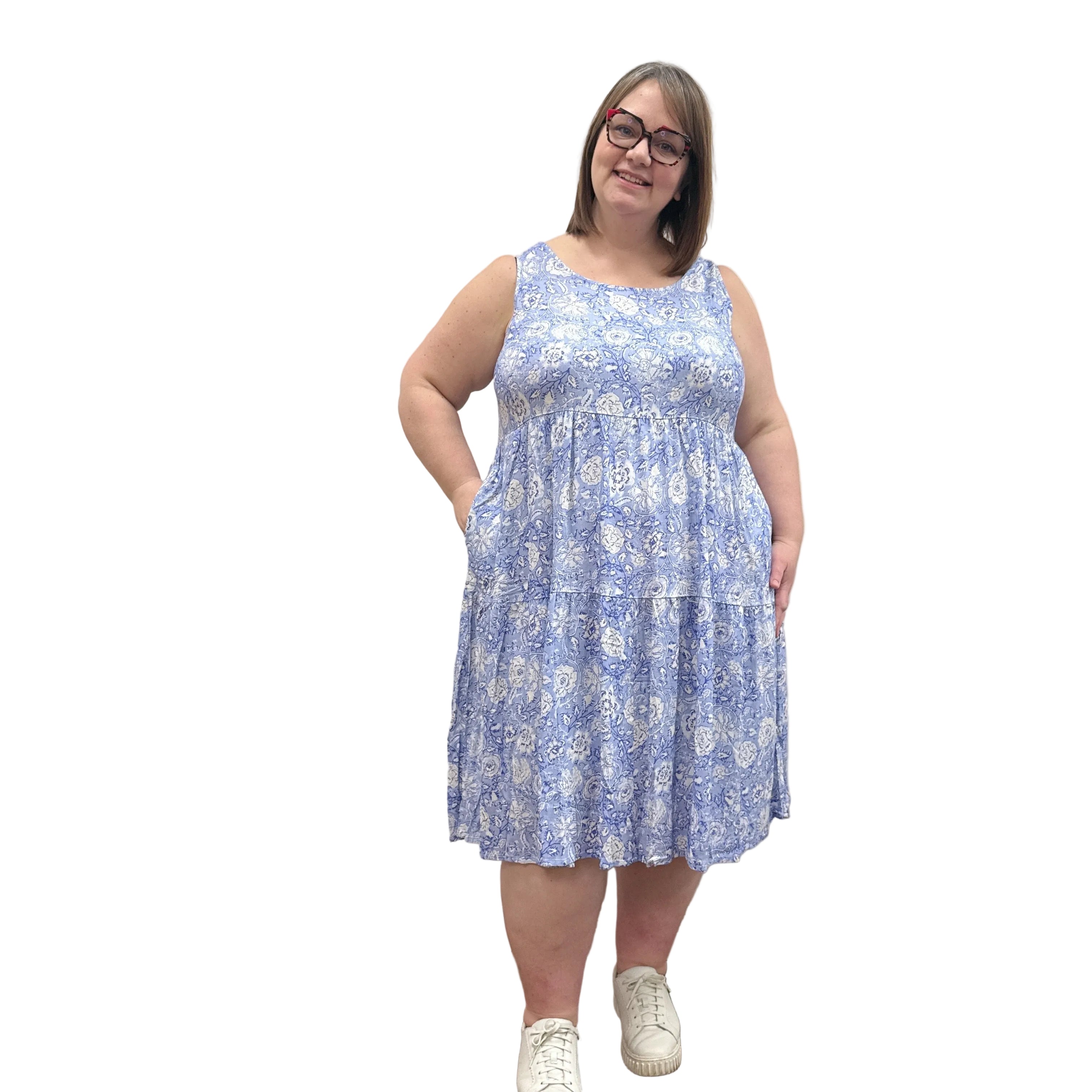 Woman wearing a patterned Blue Sky Juni Teatime Dress on a white background. 