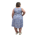 Woman wearing a patterned Blue Sky Juni Teatime Dress on a white background. 