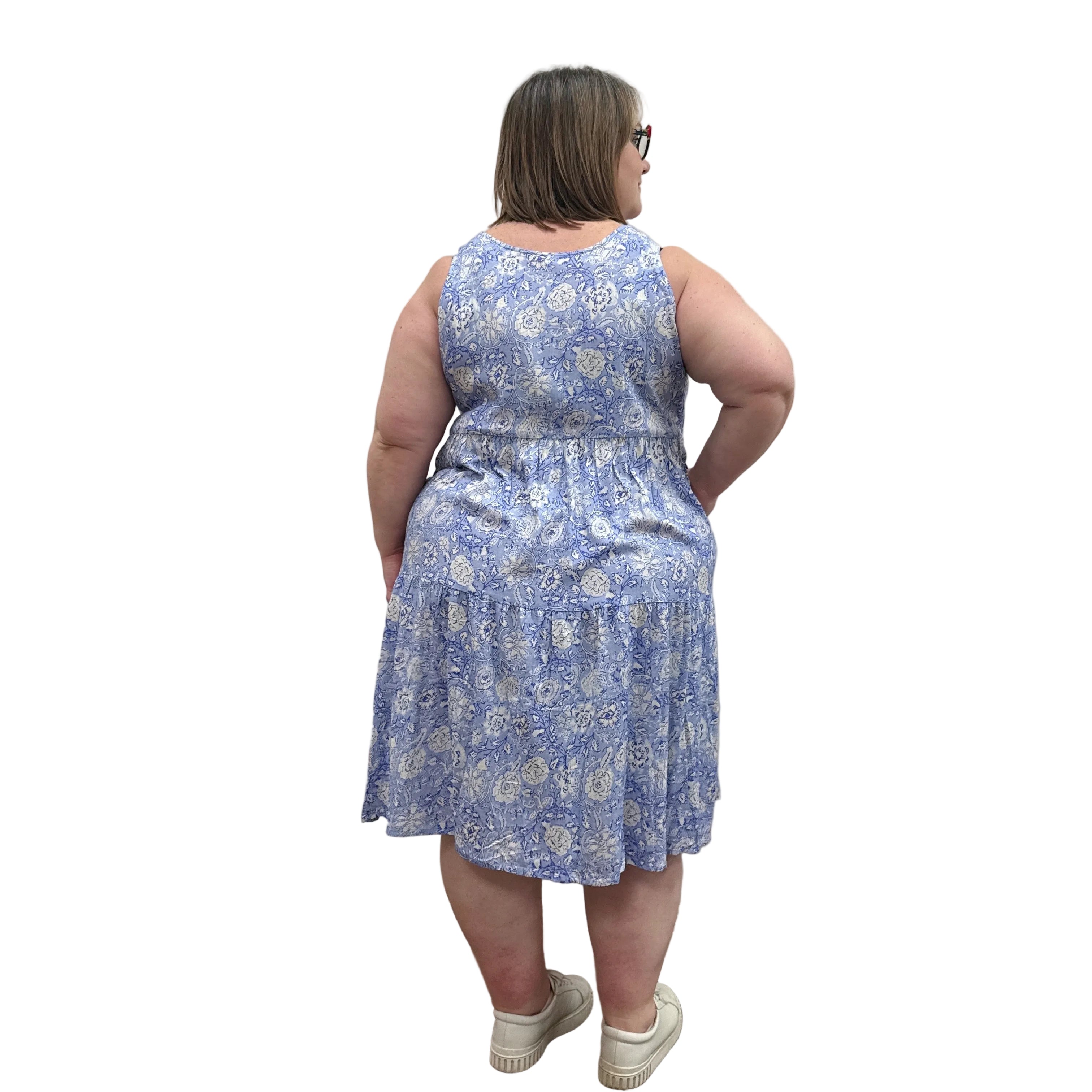 Woman wearing a patterned Blue Sky Juni Teatime Dress on a white background. 