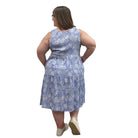 Woman wearing a patterned Blue Sky Juni Teatime Dress on a white background. 