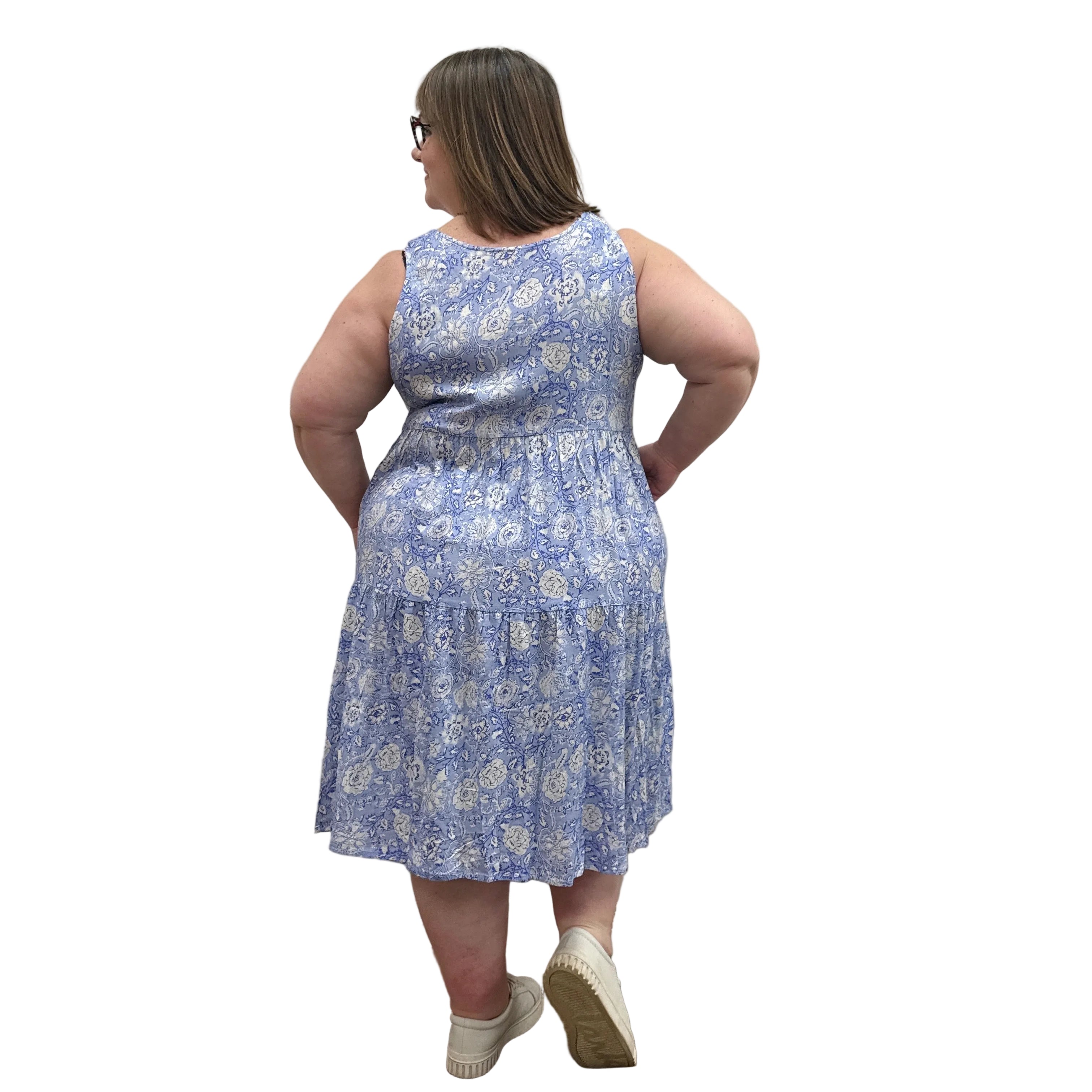 Woman wearing a patterned Blue Sky Juni Teatime Dress on a white background. 