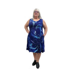 Woman wearing a blue patterned Blue Sky Sara Dress on white background. 