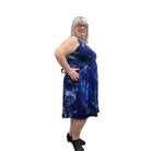 Woman wearing a blue patterned Blue Sky Sara Dress on white background. 
