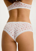 Micro Hipster in Red Rose White panty with floral pattern on a model, showing the back view. 
