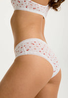 White floral Micro Hipster Panty on a model against a white background. Showing the side view. 