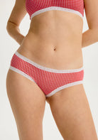 Blush Micro Hipster in Ruby panty, Red and white checkered underwear on a model against a white background. 