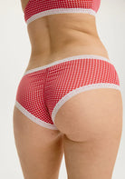 Blush Micro Hipster in Ruby panty, Red and white checkered underwear on a model against a white background showing the back view. 