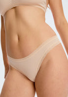 The Micro Thong panty in nude on a model showing the front. 