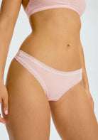 Micro Thong in Soft Pink panty on a model shown from the front view. 