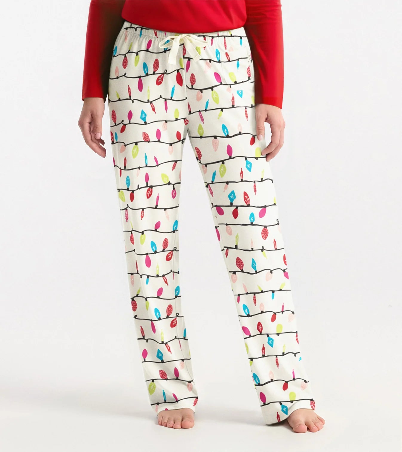 Person wearing pajama pants with colorful light bulb pattern on a white background