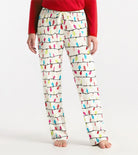 Person wearing pajama pants with colorful light bulb pattern on a white background