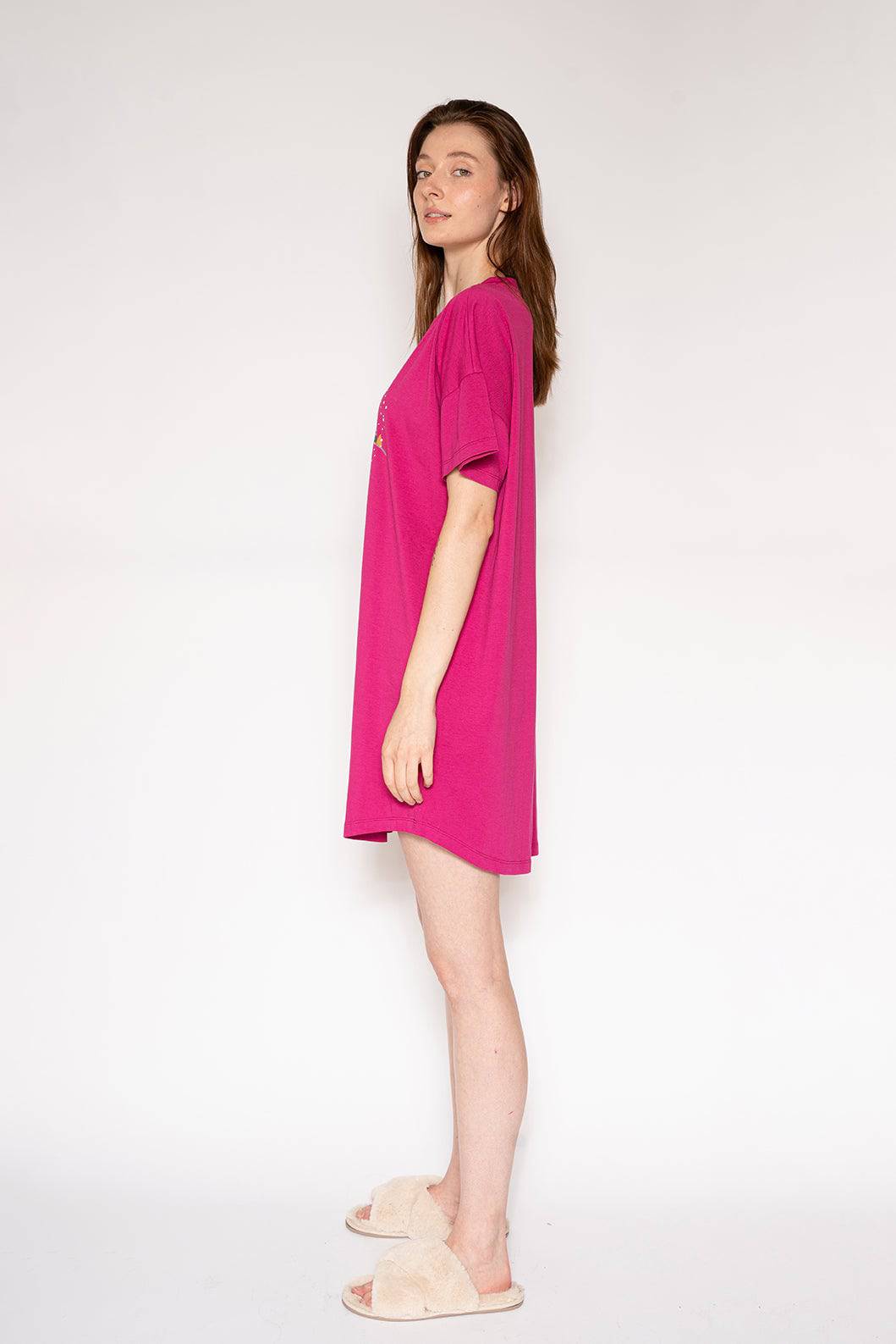 Woman wearing a bright pink dress on a white background