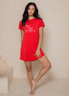 Woman wearing a red nightshirt with text on a beige background