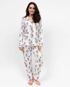 Woman wearing a patterned pajama set on a white background
