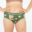 Green underwear with 'Devon + Lang' branding and coffee-themed design on a plain background