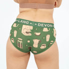 Green underwear with 'Devon + Lang' branding and coffee-themed design on a plain background