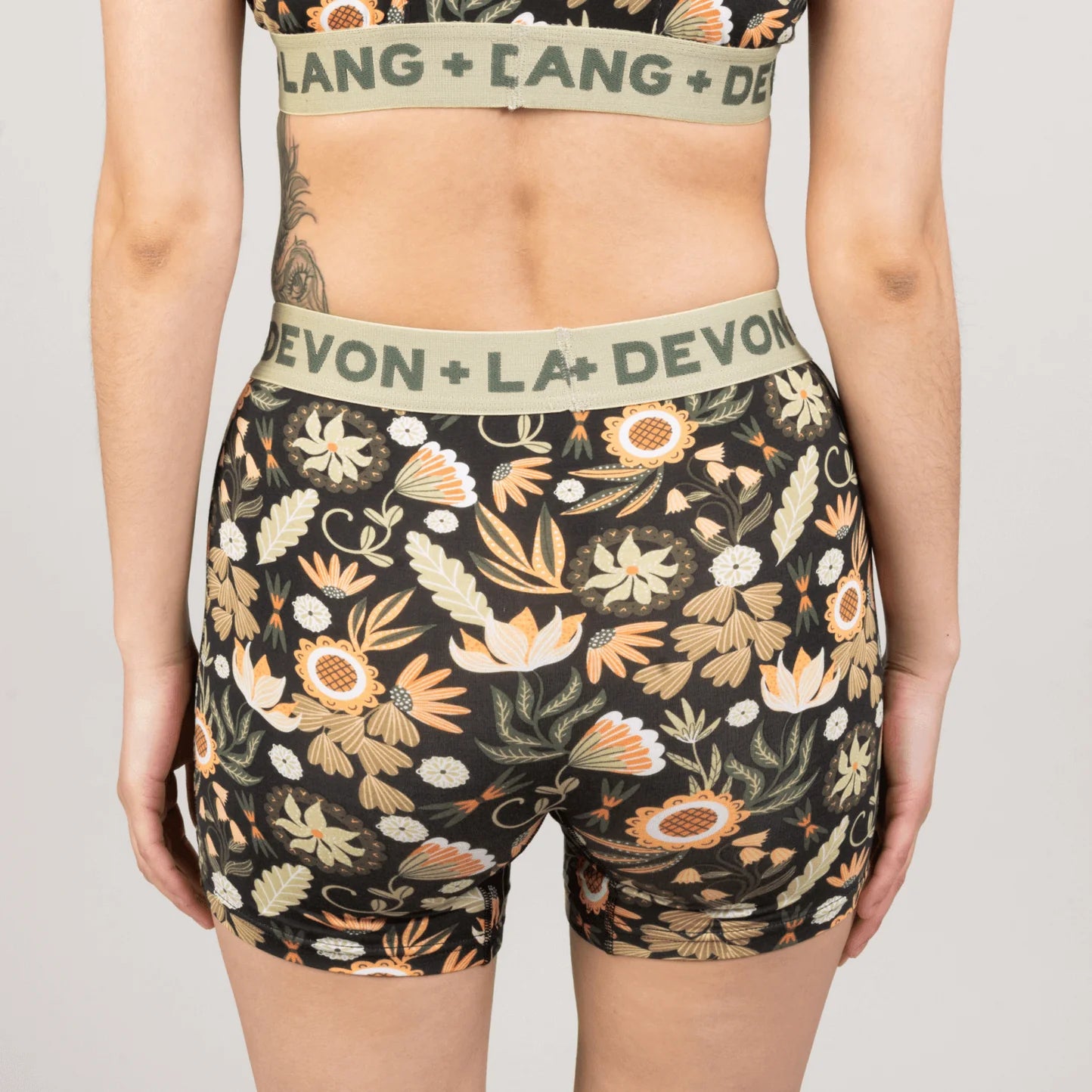 Floral patterned underwear with brand name on waistband against a neutral background