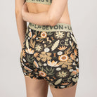 Floral-patterned shorts worn by a person on a plain background