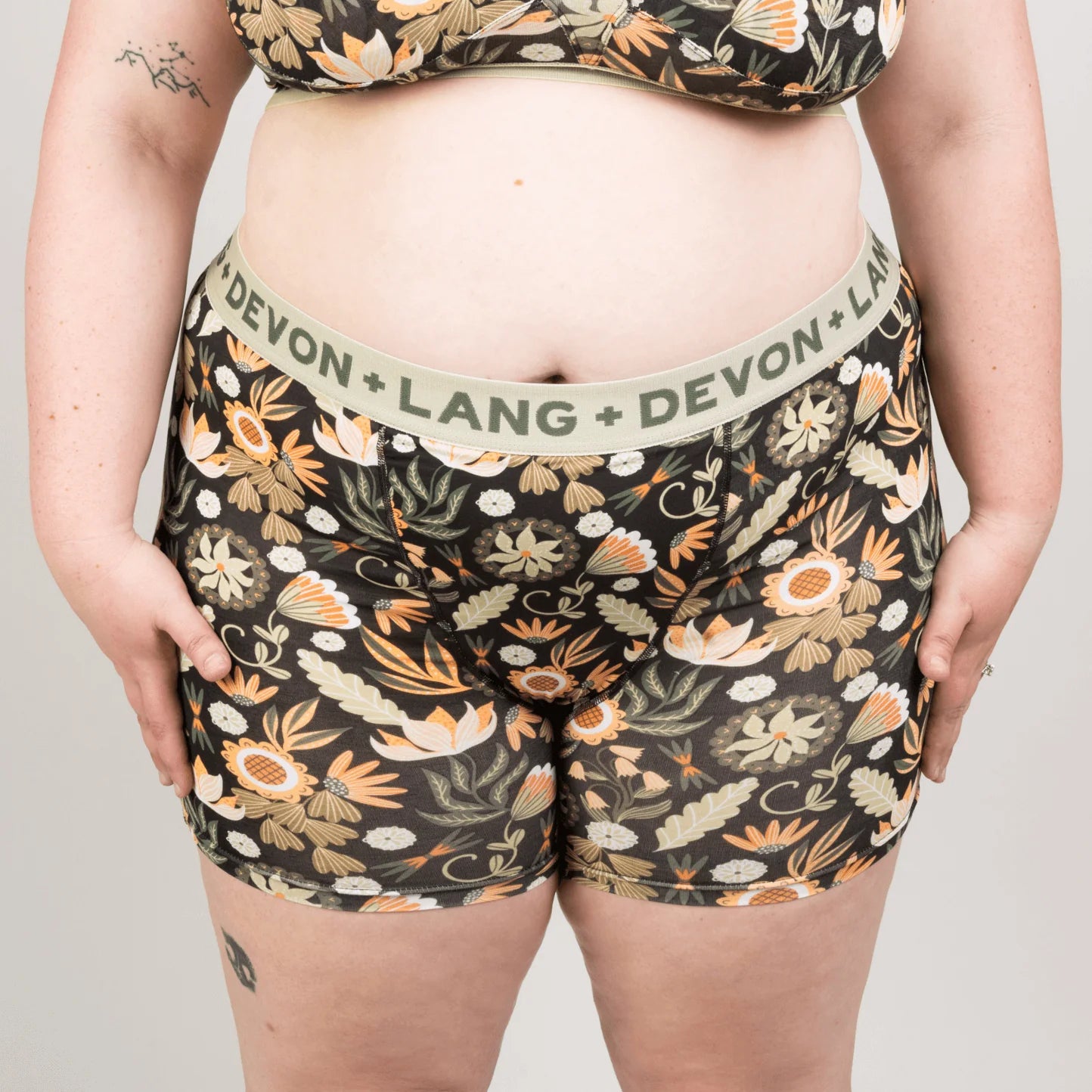 Floral patterned underwear with ''Devon + Lang'' waistband on a plain background