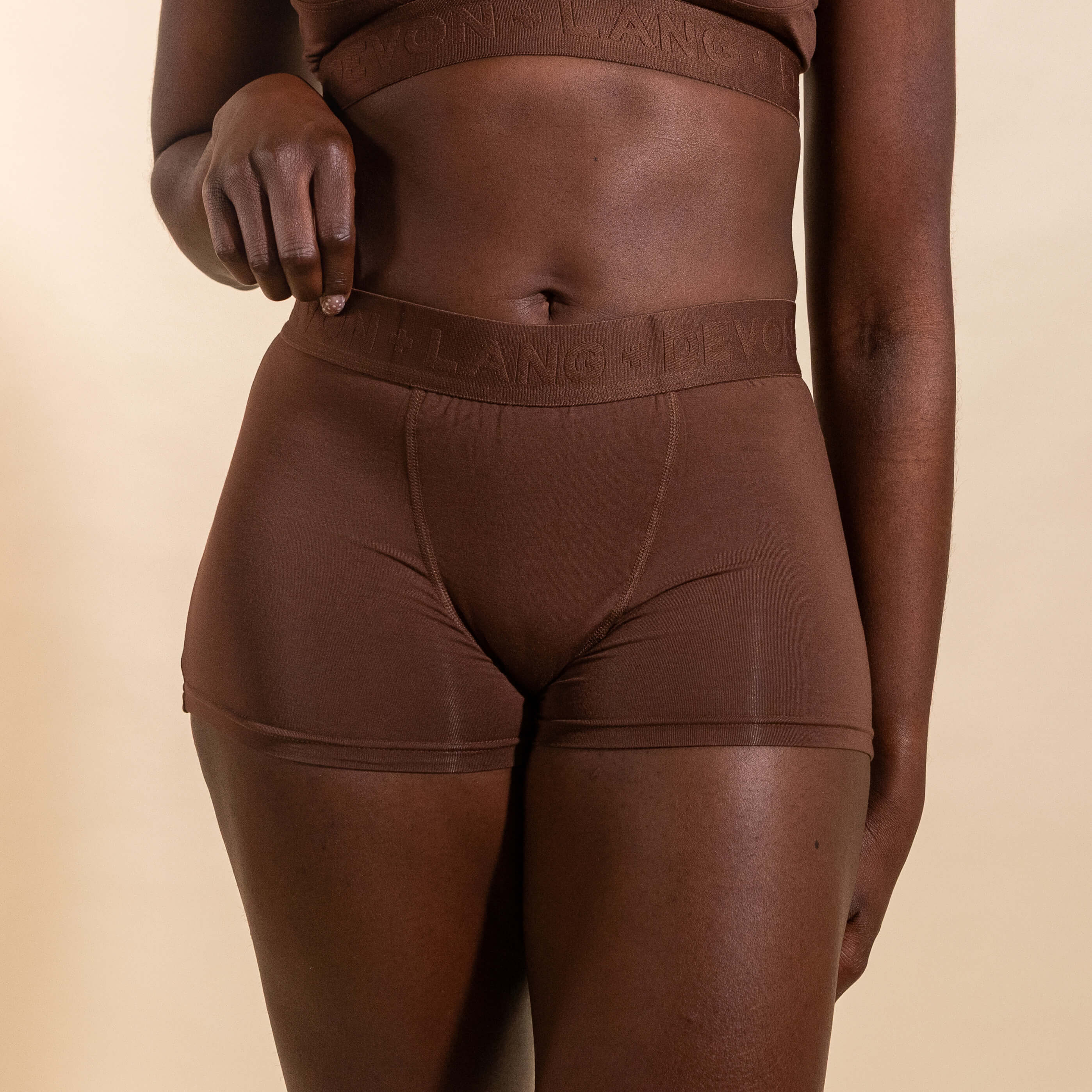 Brown underwear with brand logo on a beige background