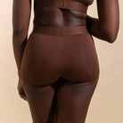 Brown underwear with brand logo on a beige background