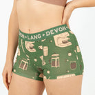 Green underwear with coffee-themed design and 'Devon + Lang' branding on a white background