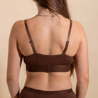 Brown bra worn by a person on a beige background