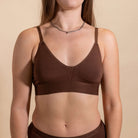 Brown bra worn by a person on a beige background