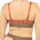 Green and red plaid bra and underwear set with visible branding on a plain background