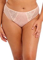 Lace pink underwear worn by a person on a white background