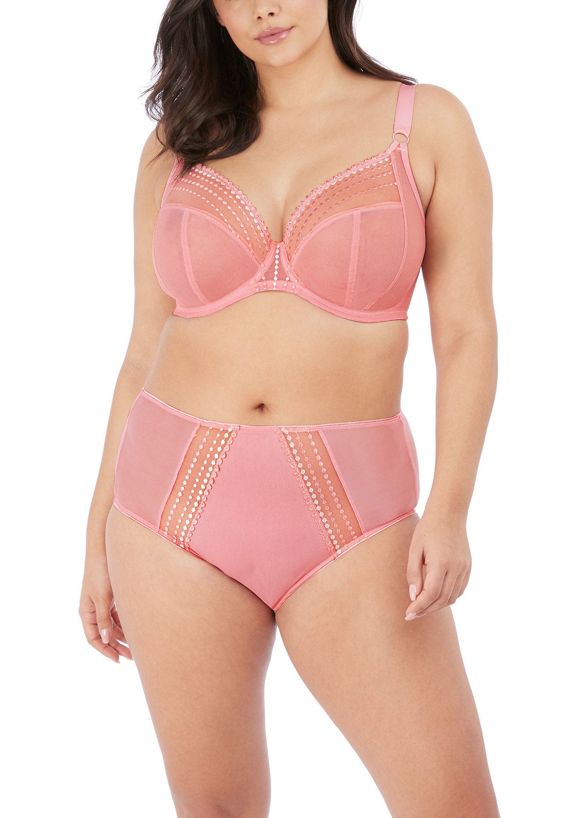 Woman wearing a pink bra and high-waisted panties set on a white background