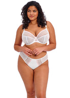Woman wearing a white lace lingerie set on a white background