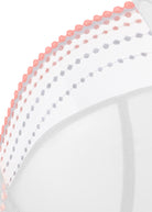 Close-up of a white bra with pink and white polka dot trim on a white background