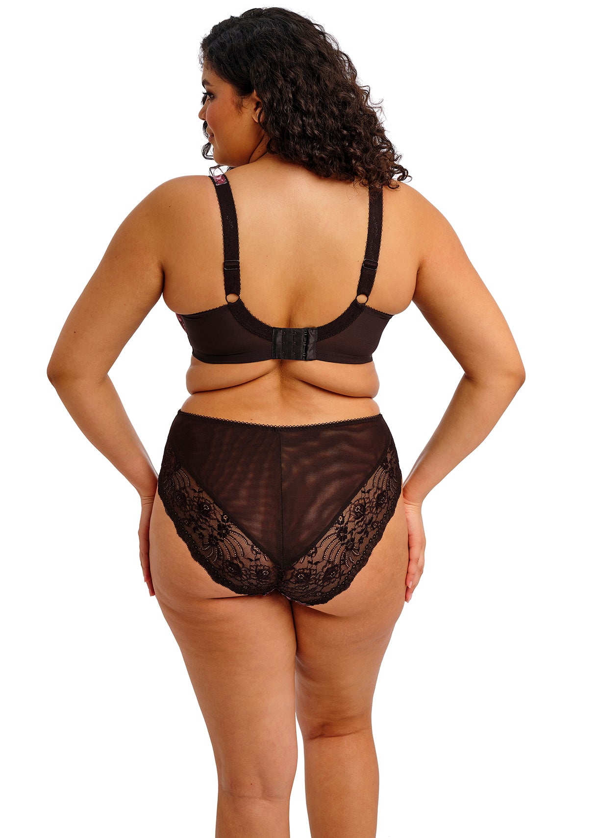 Woman wearing a black lace lingerie set on a white background