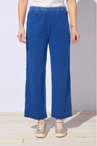 Person wearing blue pants with a white background