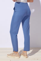 Blue pants worn by a person on a light background